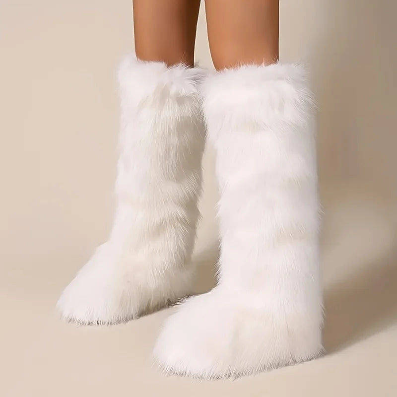 White fluffy knee-high boots on a neutral background