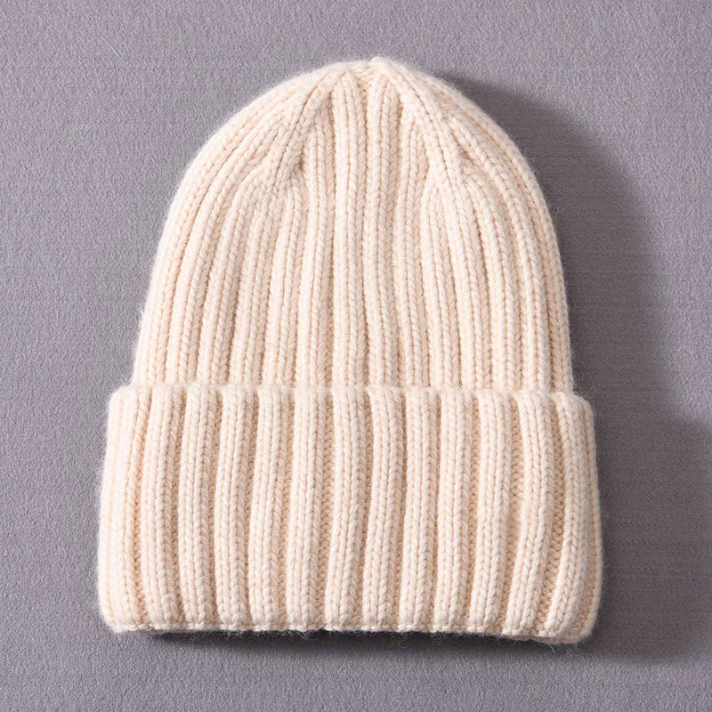 Beige knit beanie on a gray background