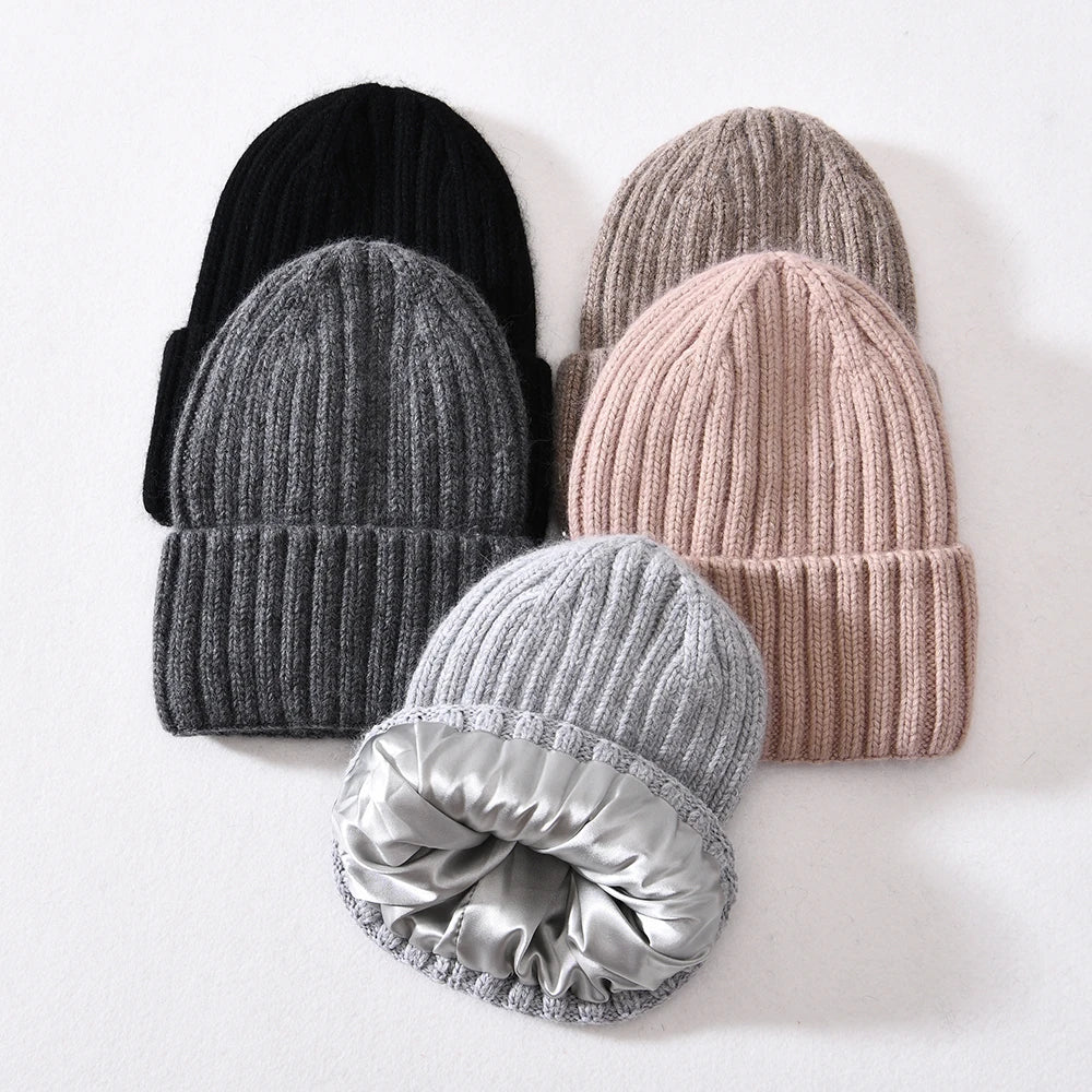 Set of knit hats in various colors on a white background