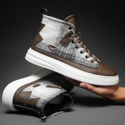 Brown and gray high-top sneakers with white soles on a dark background