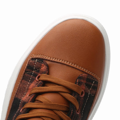 Brown sneaker with white sole on a white background