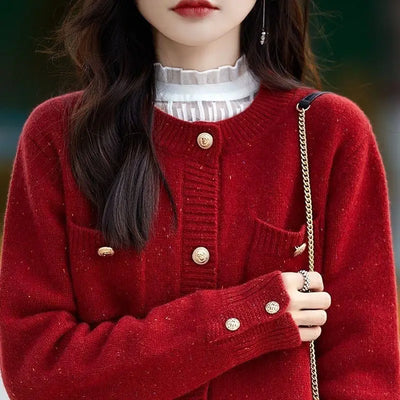 Woman wearing red knit cardigan sweater with button front and pockets close up look