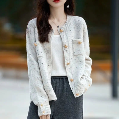 Woman in white button-front cardigan sweater