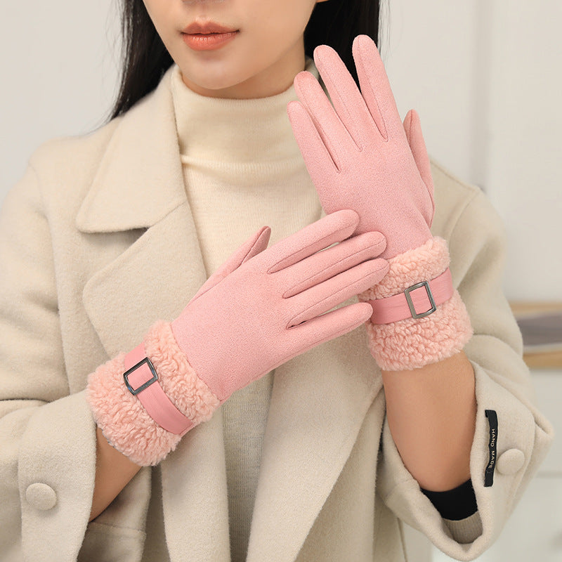 Person wearing pink gloves with fur cuffs and a beige coat.
