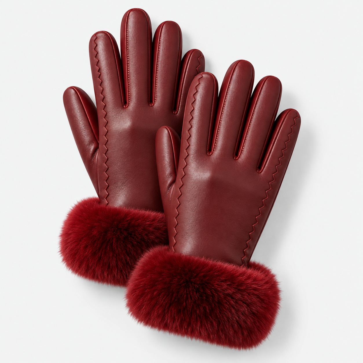 A pair of burgundy leather gloves with matching faux fur cuffs, displayed on a clean light gray background.