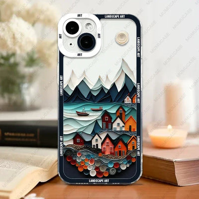 Phone case with a scenic design of houses and mountains on a table with books and a candle.