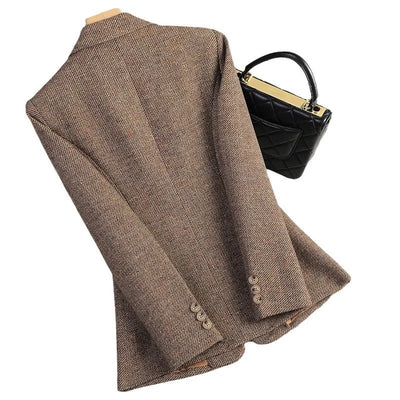 Brown blazer and black handbag on a white background