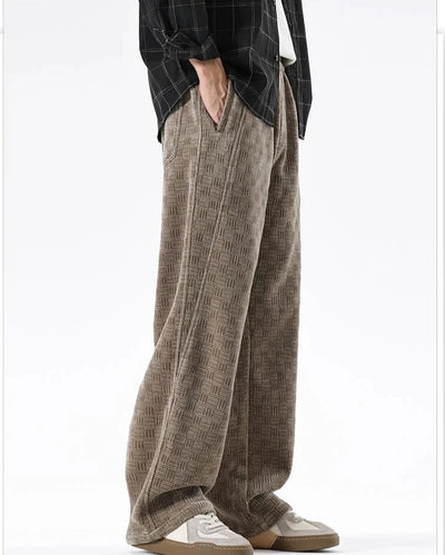 Person wearing brown plaid pants with a white background