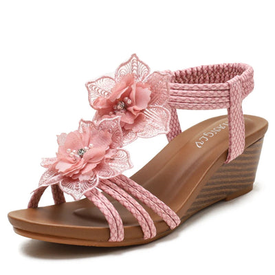 Pink sandal with floral design on a white background