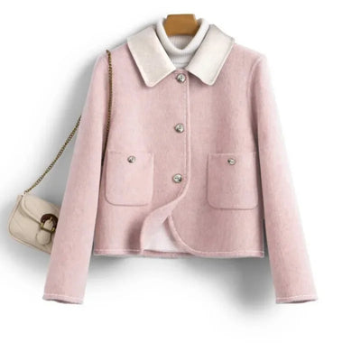 Pink jacket with white collar on a hanger against a white background