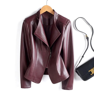 Purple leather jacket on a hanger with a black handbag on a white background