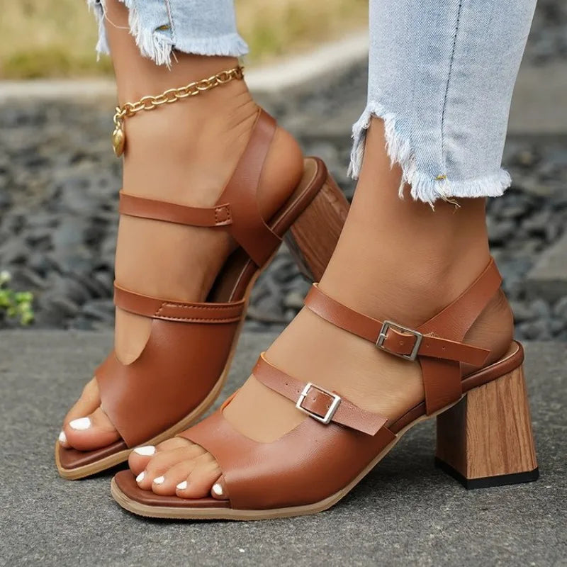 Brown sandals with wooden heel on a blurred outdoor background