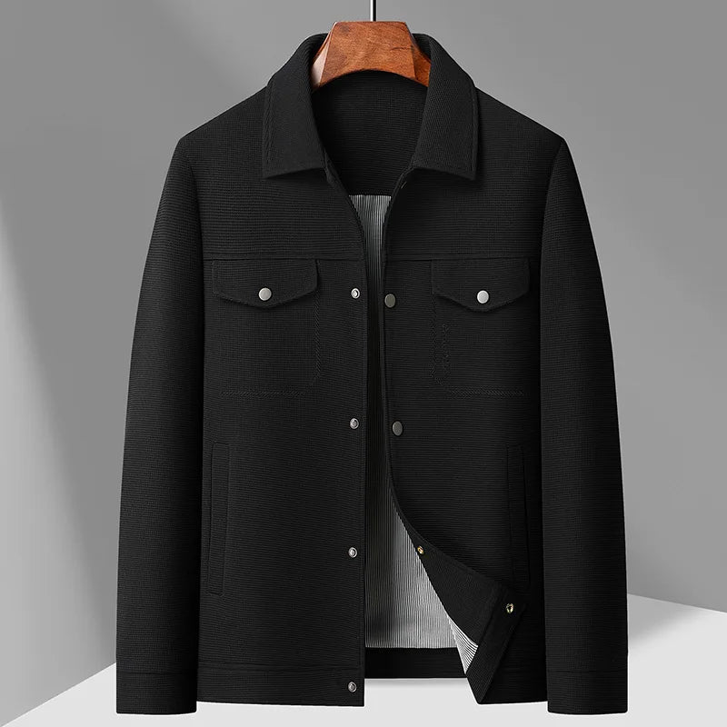 Black jacket on a hanger against a gray background