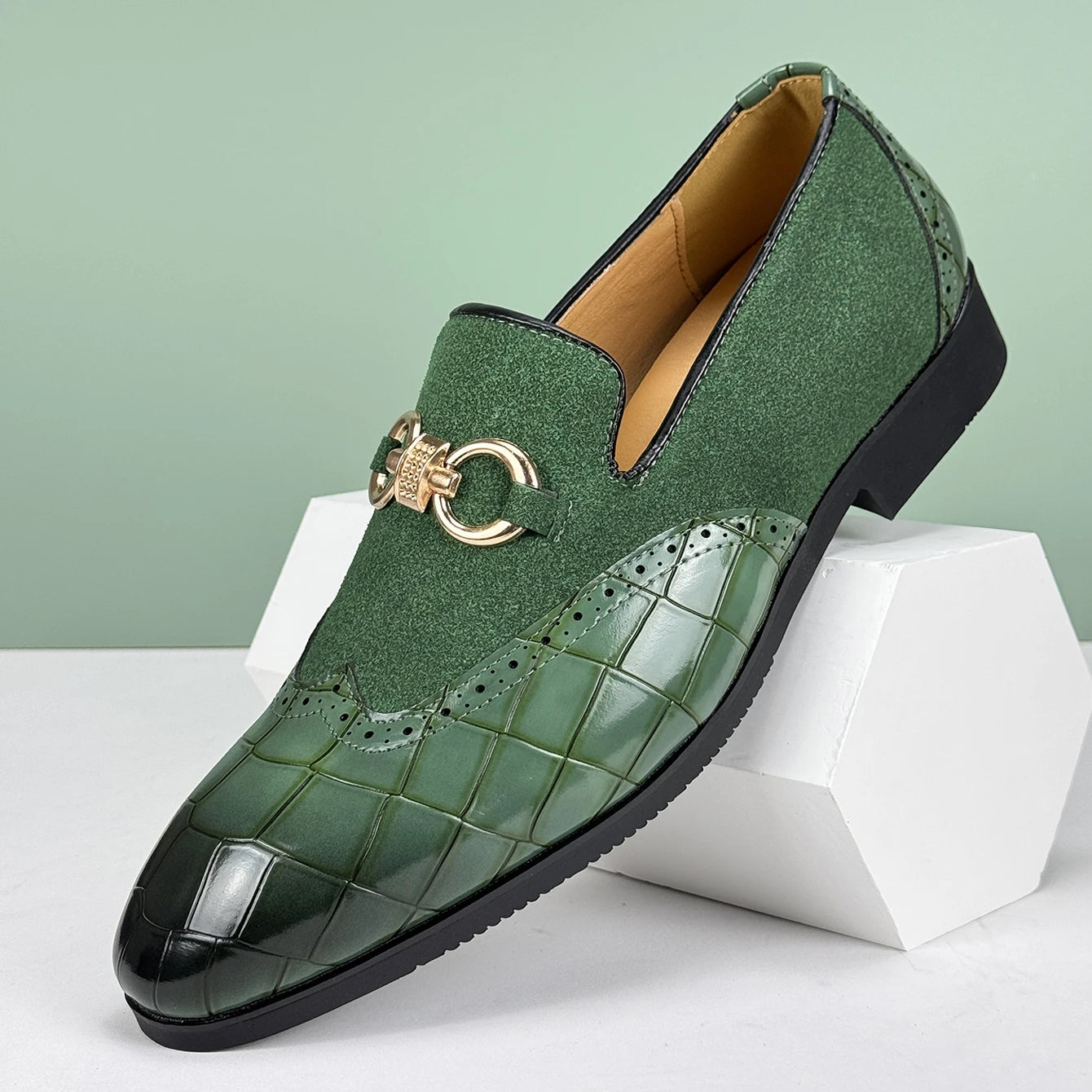 Green loafers with a decorative buckle on a light green background