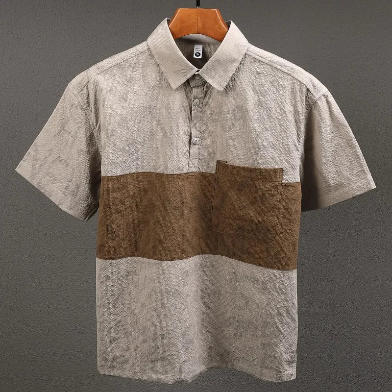 Short-sleeve shirt with brown and beige pattern on a hanger against a gray background