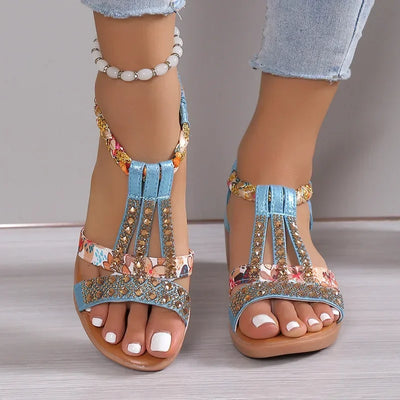 Decorative sandals with embellishments on a neutral background