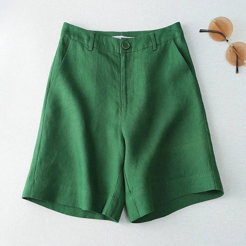Green shorts on a white background with sunglasses in the corner