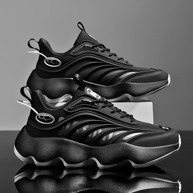 Black sneakers with reflective accents on a gray background