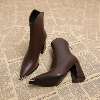 Brown ankle boots on a newspaper background