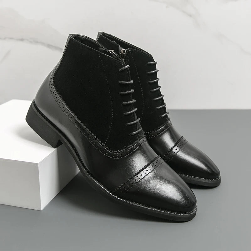 Black leather boots with a white box on a gray surface