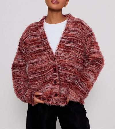 Person wearing a textured pink cardigan on a white background