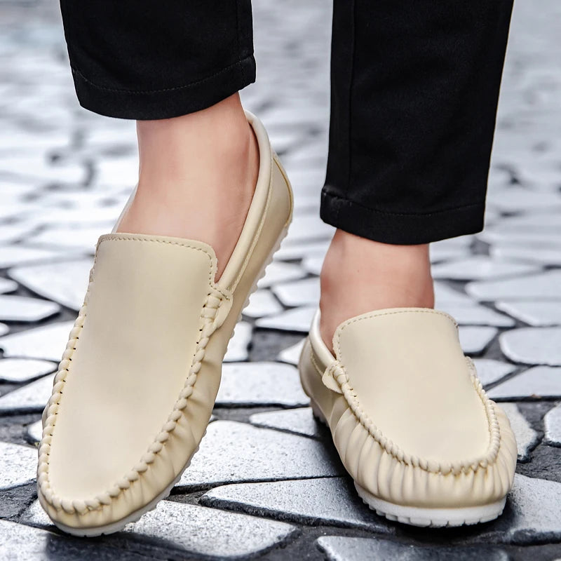Beige loafers worn on a stone pavement
