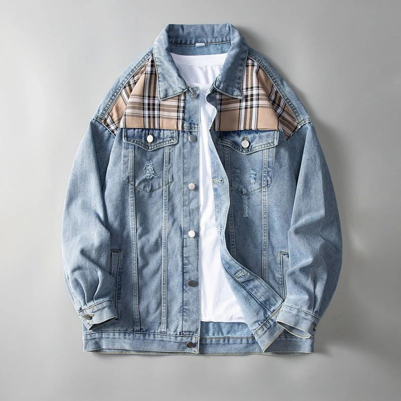 Denim jacket with plaid accents on a gray background