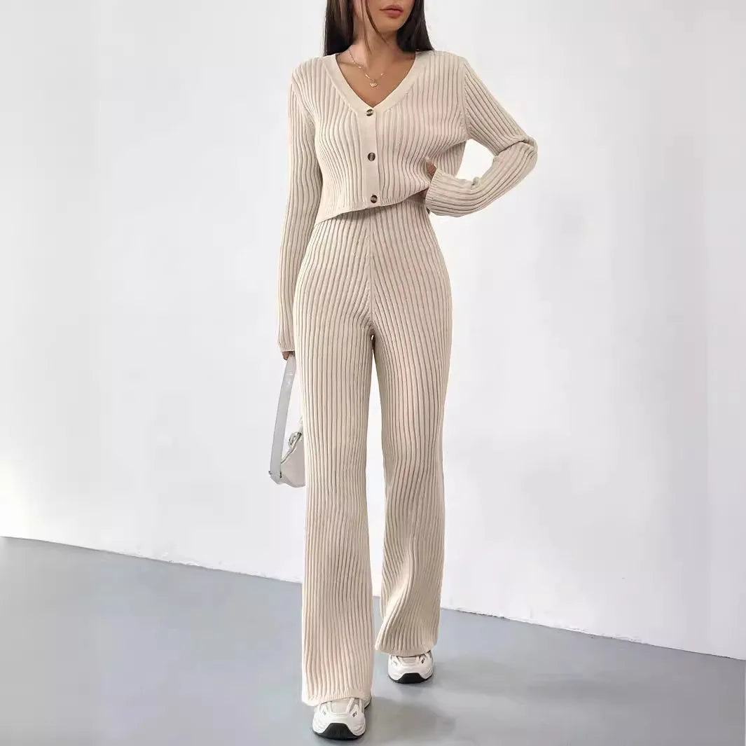 Woman wearing a beige ribbed sweater and pants set on a white background