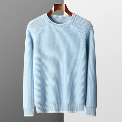 Light blue sweater on a hanger against a gray background