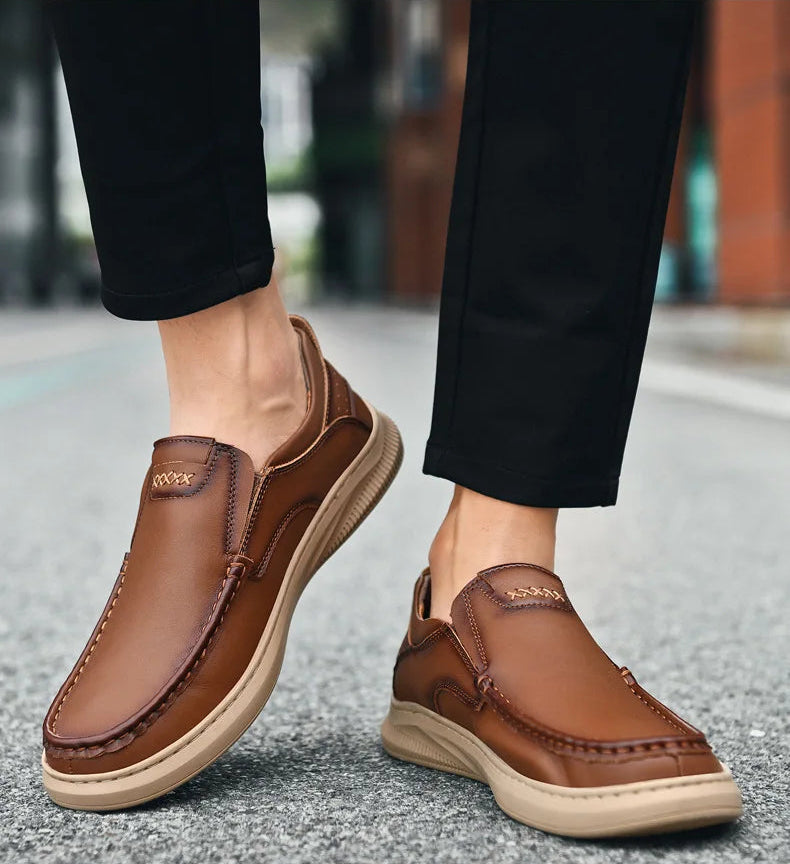 Brown leather shoes worn with black pants on a blurred street background