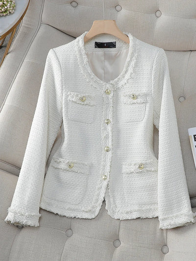 White textured jacket on a hanger against a gray upholstered background