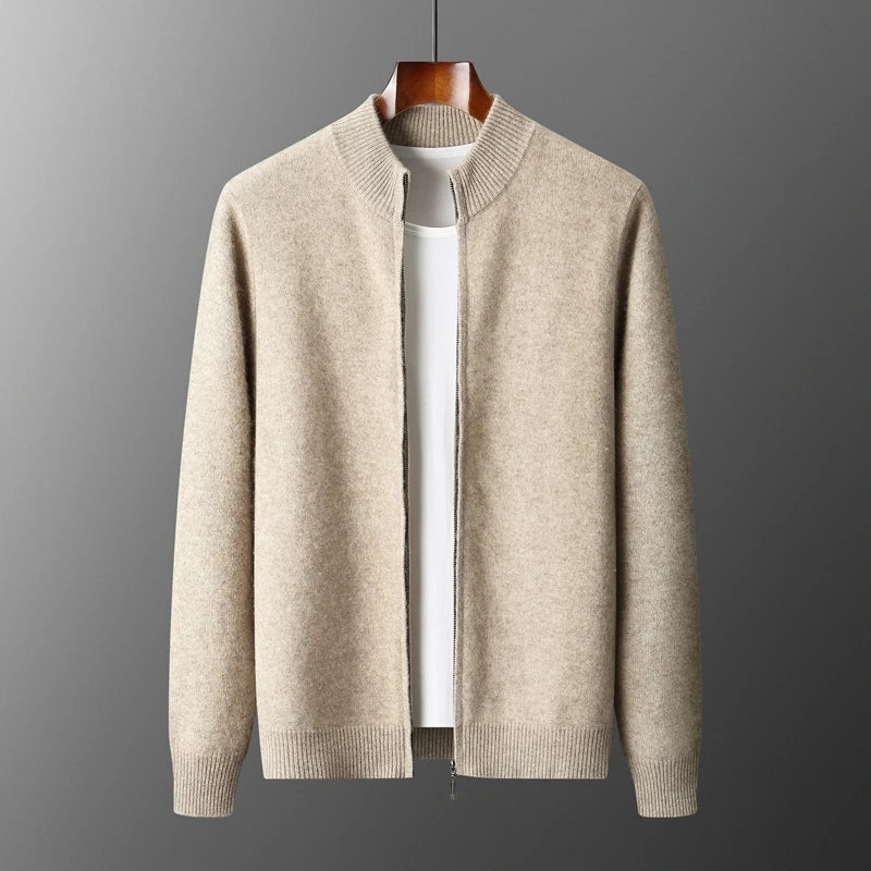Beige sweater on a hanger against a gray background