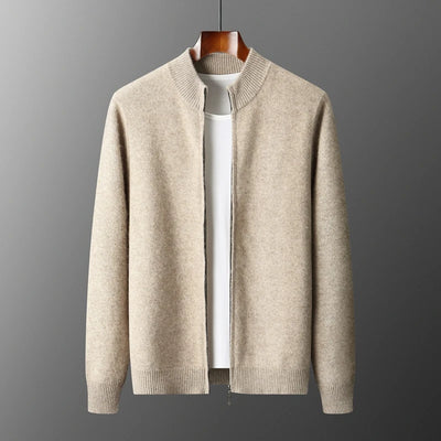 Beige sweater on a hanger against a gray background