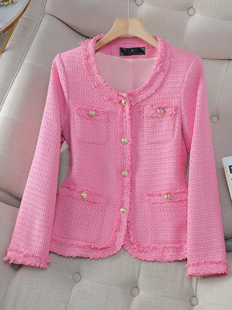 Pink textured jacket on a hanger against a neutral background