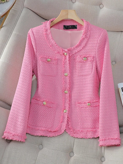Pink textured jacket on a hanger against a neutral background