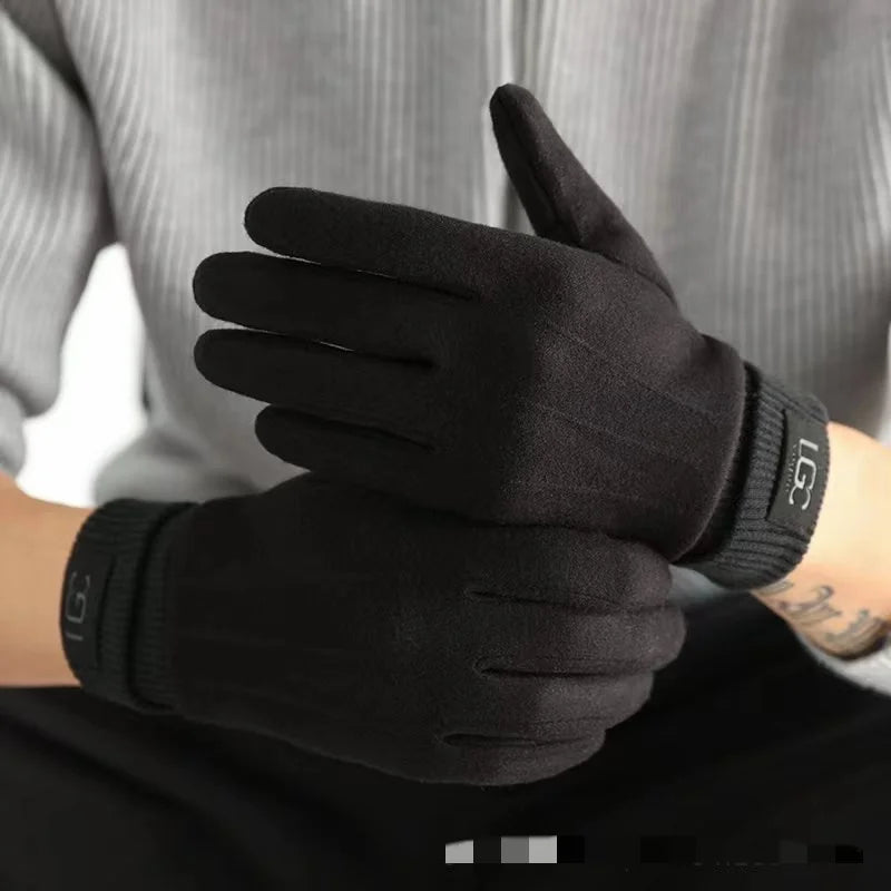 Black gloves with brand logo worn by a person against a neutral background