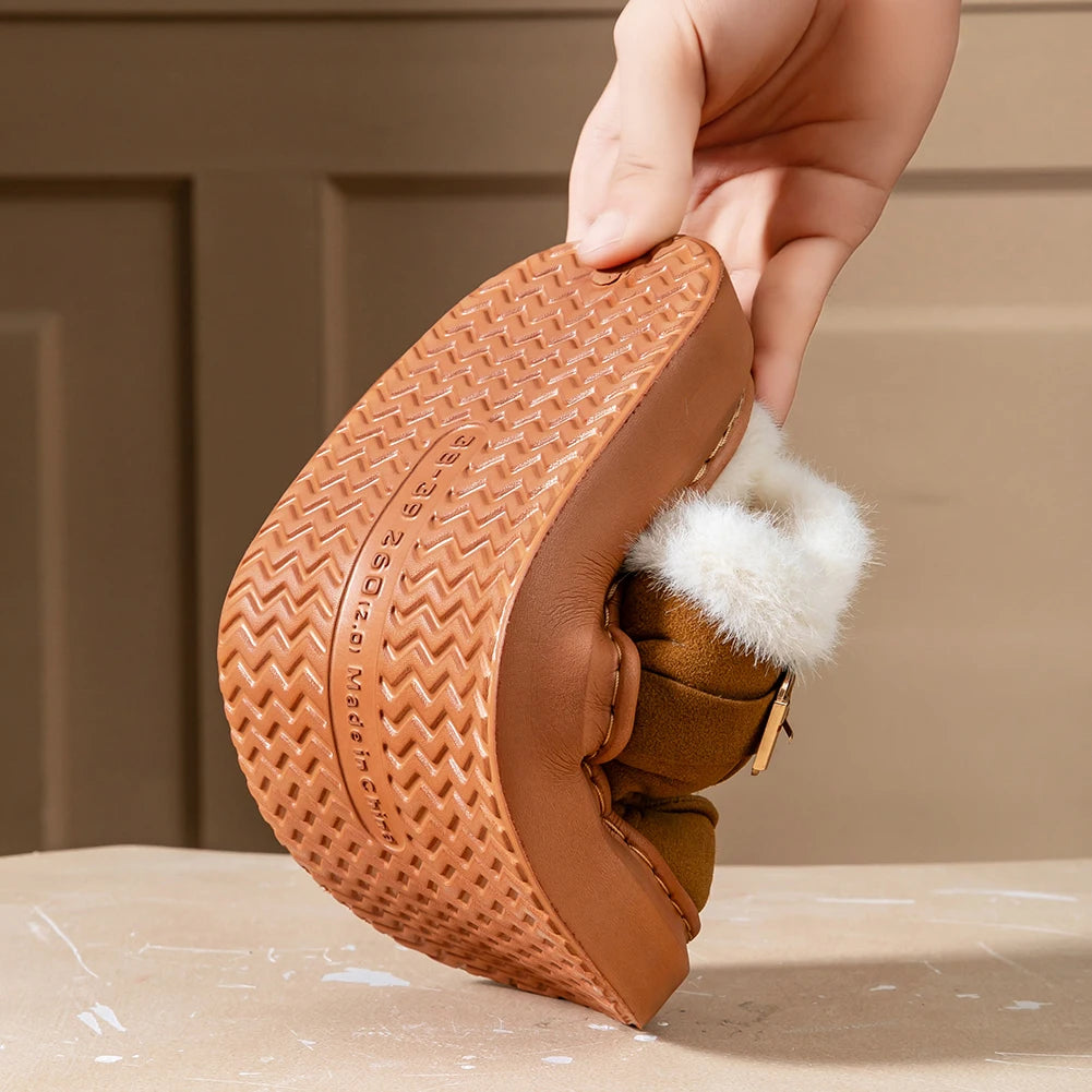 Brown shoe with white fur lining held by a hand against a beige background