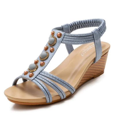 Gray wedge sandal with decorative elements on a white background