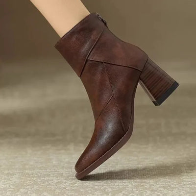 Brown leather ankle boot on a neutral background