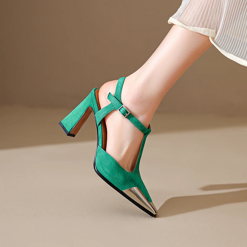 Green high-heeled shoes worn by a person on a beige background