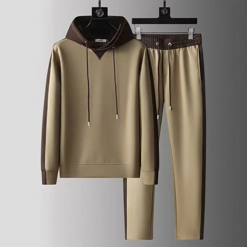 Beige tracksuit with brown accents on hangers against a gray background