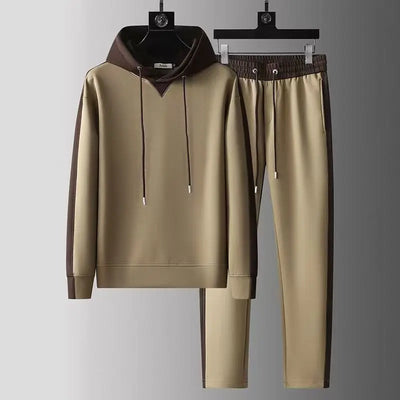 Beige tracksuit with brown accents on hangers against a gray background