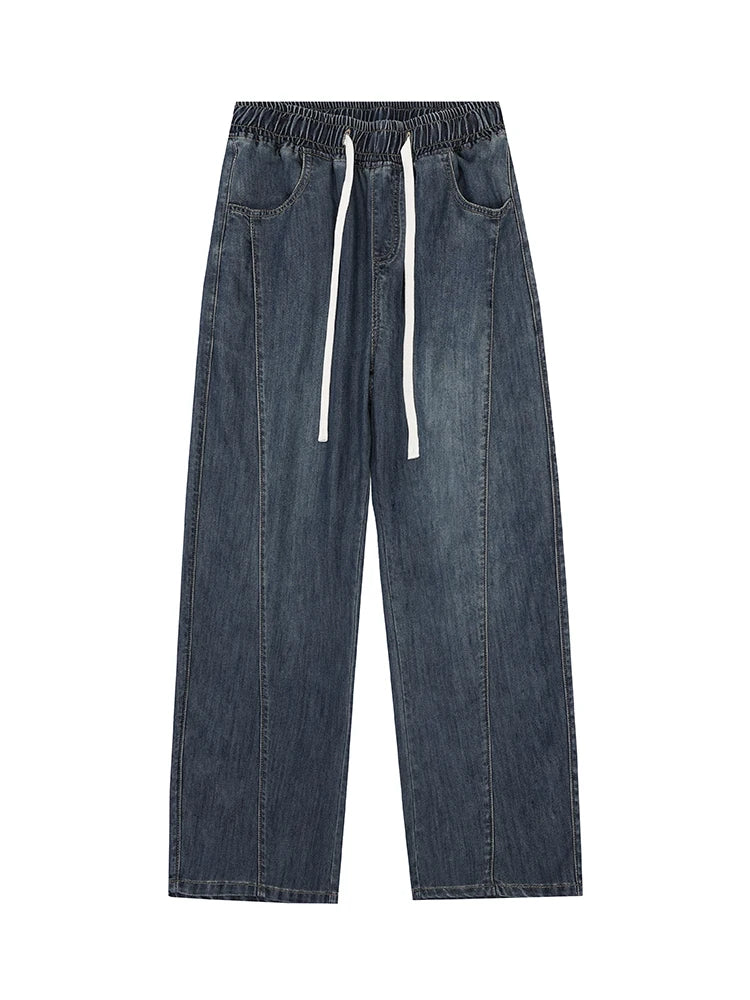 Blue denim pants with drawstring on a white background