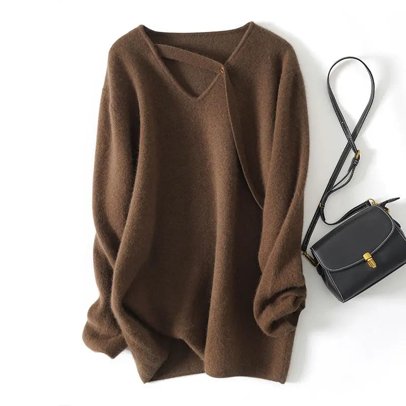 Brown sweater and black handbag on a white background