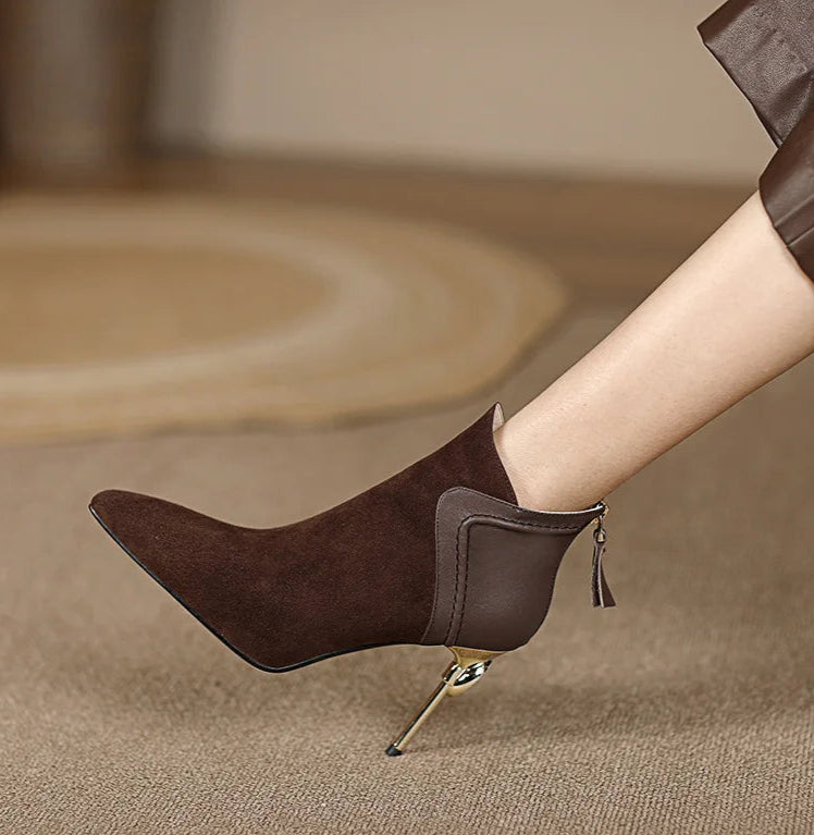 Brown high-heeled shoes with a tassel on a beige background