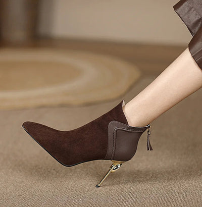 Brown high-heeled shoes with a tassel on a beige background