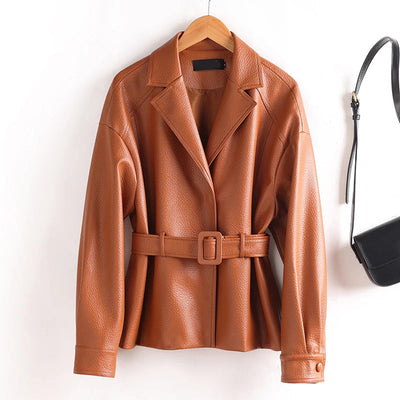 Brown leather jacket with a belt on a hanger against a white background