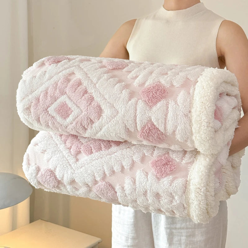 Person holding a stack of pink and white textured blankets