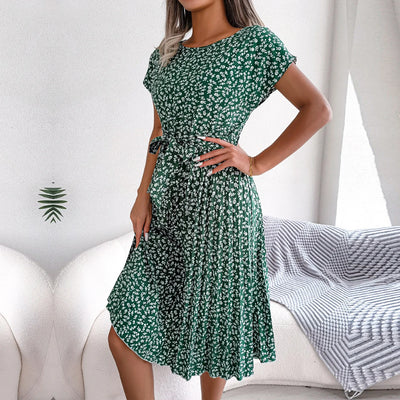 Woman wearing a green floral dress in a casual setting