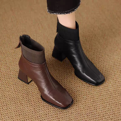 Brown and black ankle boots on a textured brown background